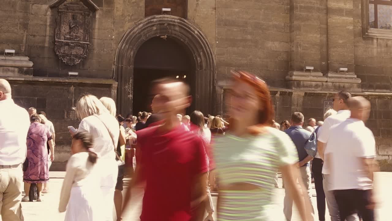 Time Lapse of a Busy Crowd Walking in Front of an Old City Building