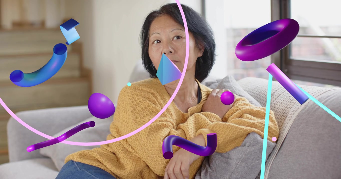 Senior woman resting on sofa and pondering, starting technology demo with floating 3D shapes