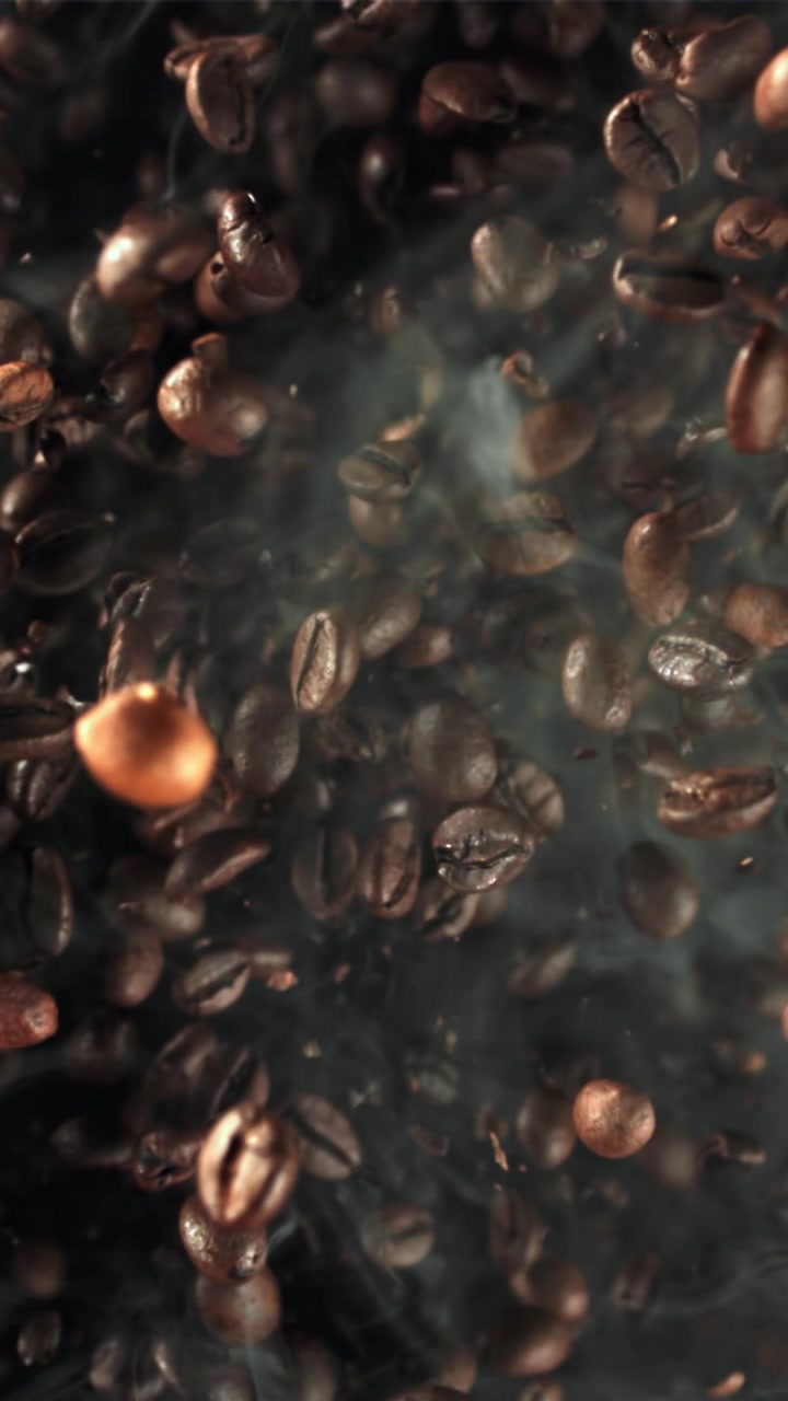 Roasted Coffee Beans Falling in Slow Motion with Aromatic Smoke