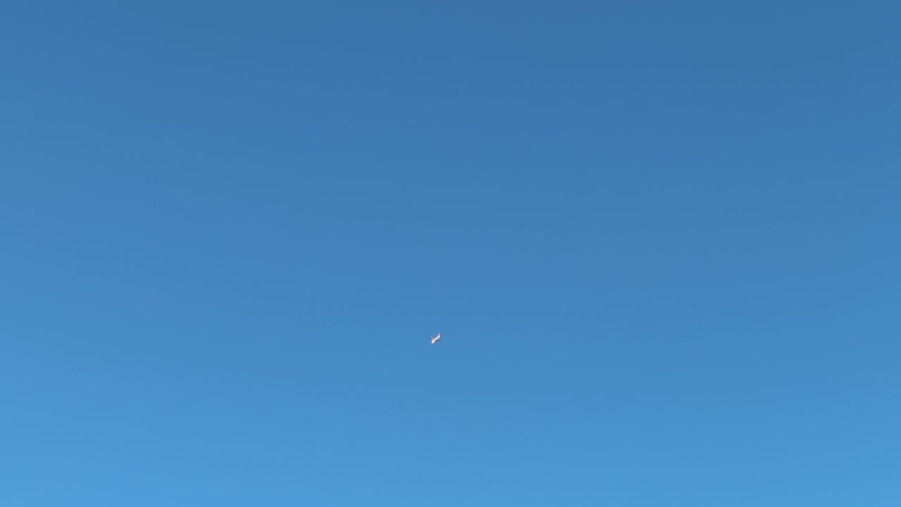 A passenger plane flying high up in the sky over the Cape Peninsula in South Africa.