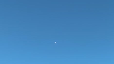 a passenger plane flying high up in the sky over the cape peninsula in south africa.