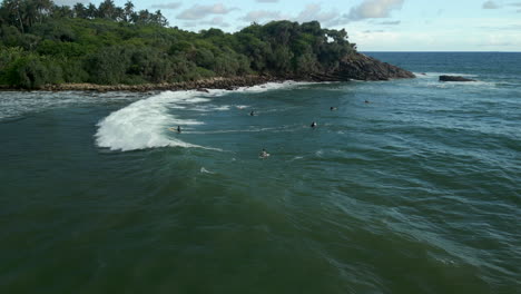 Slow-Motion-Aerial-Drone-Shot-of-Caucasian-Male-Paddling-and-Failing-to-Catch-a-Wave-in-Southern-Sri-Lanka