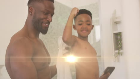 animación de luces sobre un feliz padre y hijo afroamericanos tomando selfies en el baño