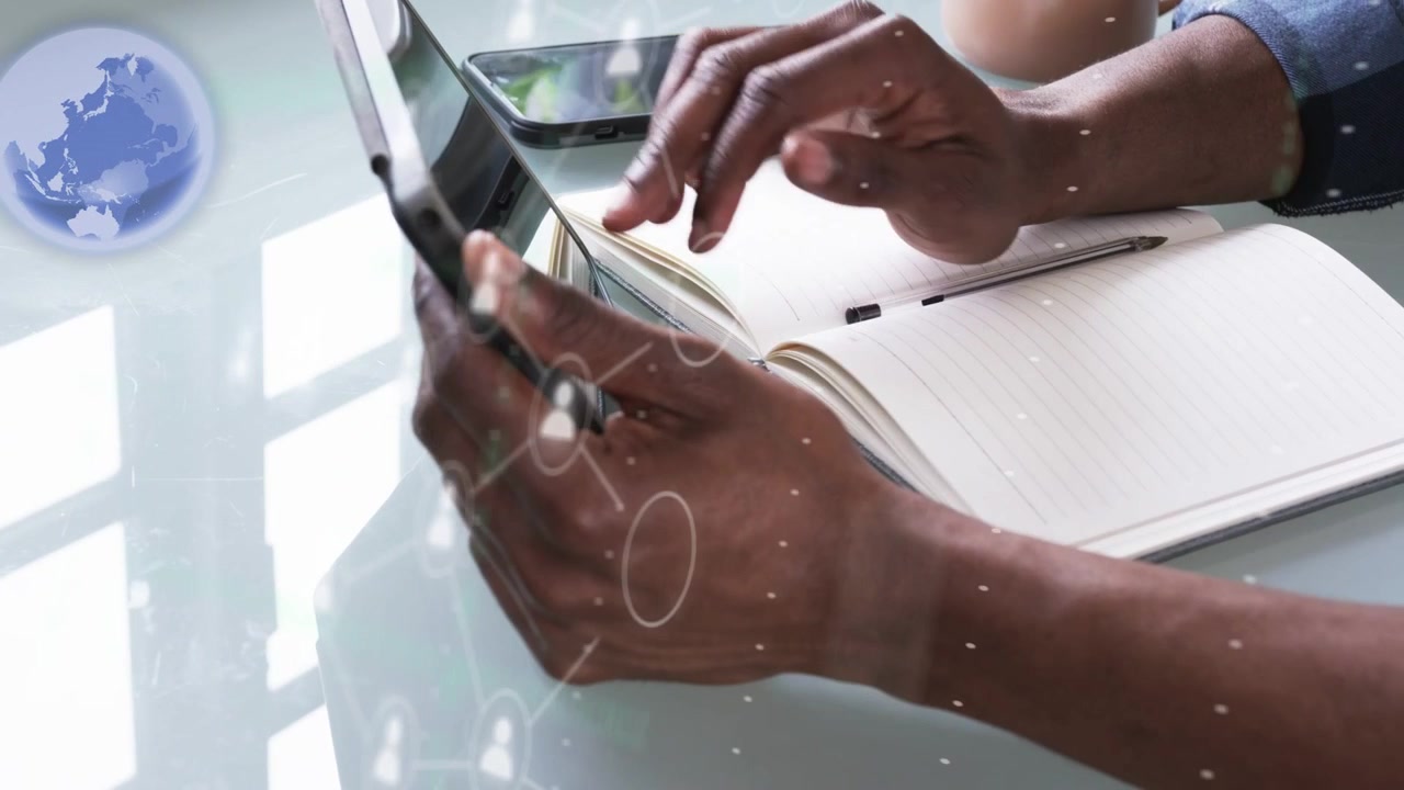 Male hands steadying tablet and tapping screen, causing contact nodes over tablet for networking