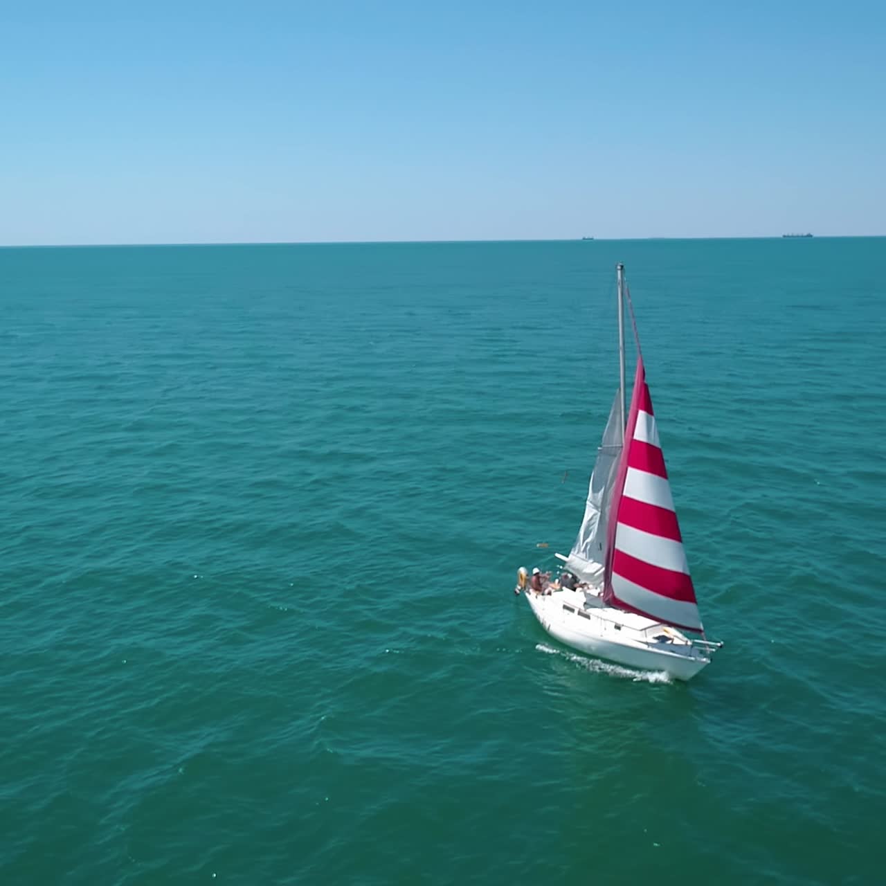 Sailboat cruise at serene seascape. Yacht sailing in open sea at windy day, aerial view