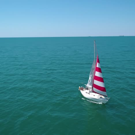 sailboat cruise at serene seascape. yacht sailing in open sea at windy day, aerial view