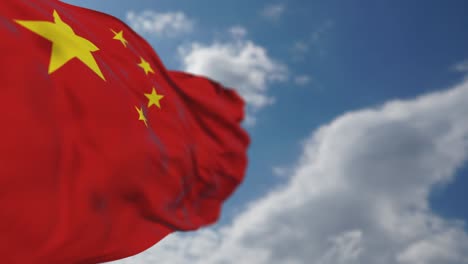 waving chinese flag in cloudy sky.