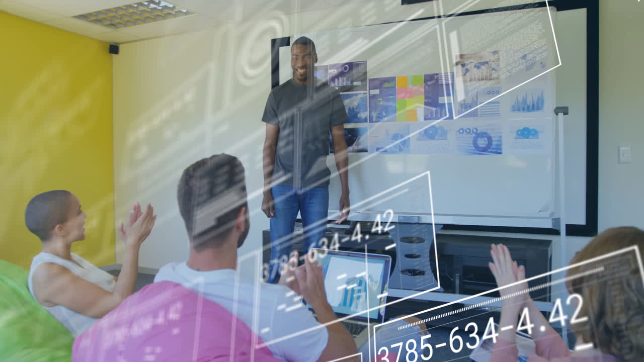 Applauding diverse team in business meeting with data processing animation overlay