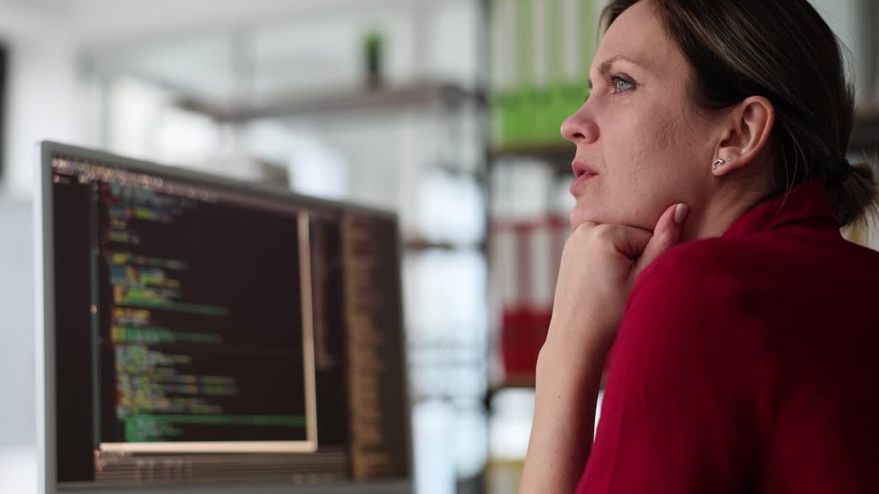 Woman working on computer with code