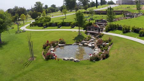 close-up panning aerial shot of a small decorated stream for the private estates gravesites at a mortuary in california