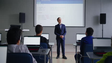 boy presenting to class on coding