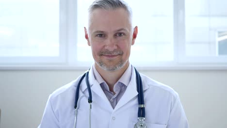 thumbs up by smiling confident doctor