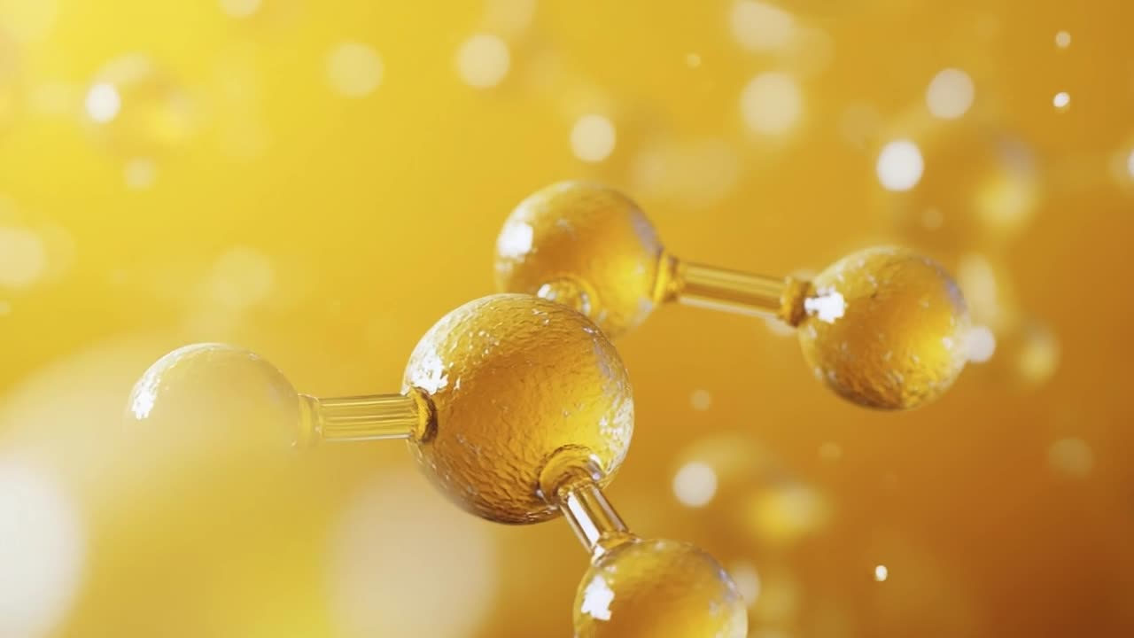 Gold liquid's molecular structure. Visualization of a molecular structure featuring golden droplets illuminated by soft light, capturing a vibrant essence.