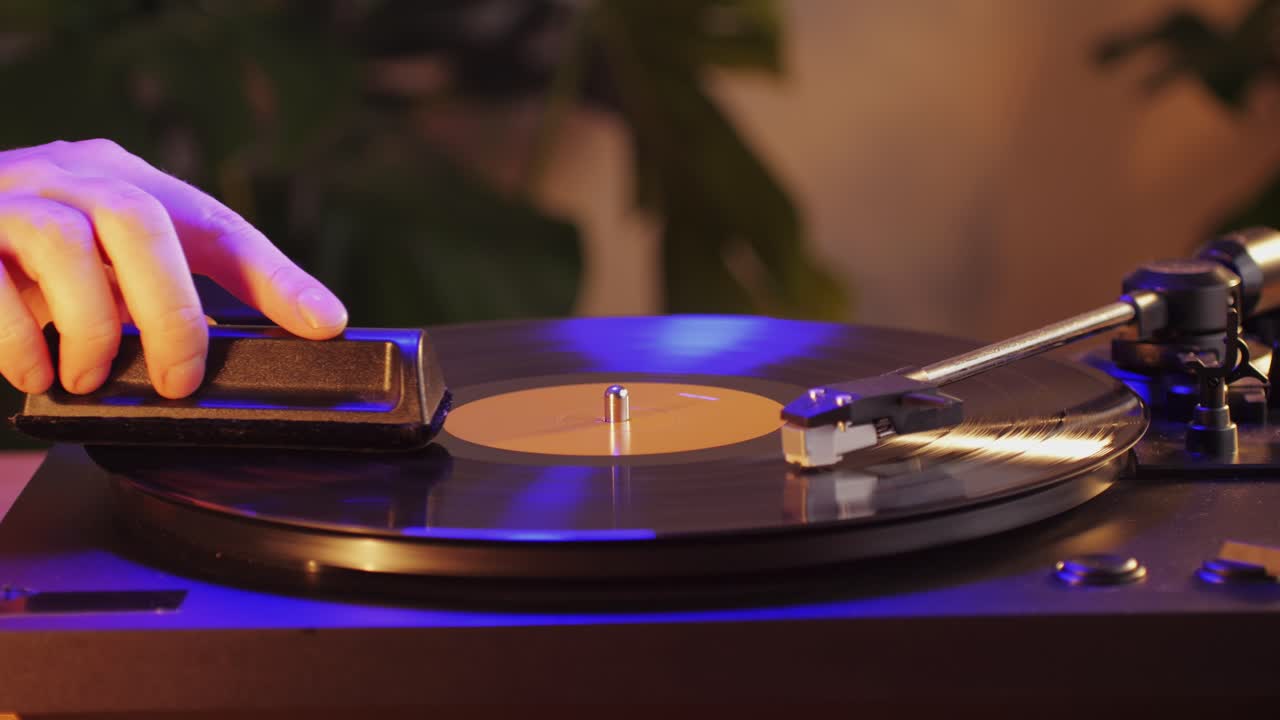 Man Cleaning retro vinyl with special brush - turntable vinyl record player, vintage record player, Sound technologies for DJ to mix and play music.
