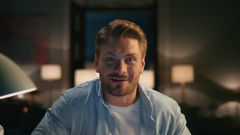 positive man laughing home closeup. guy guy having video call asking friend