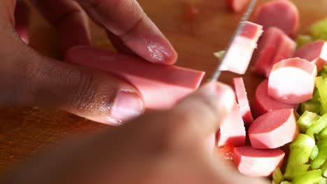 cutting sausage for a meal