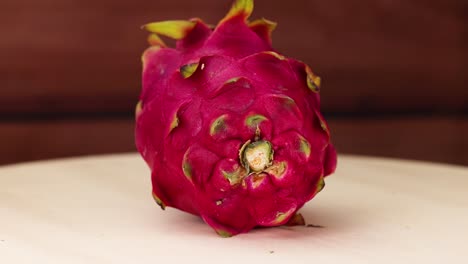 dragon fruit rotates on a wooden table