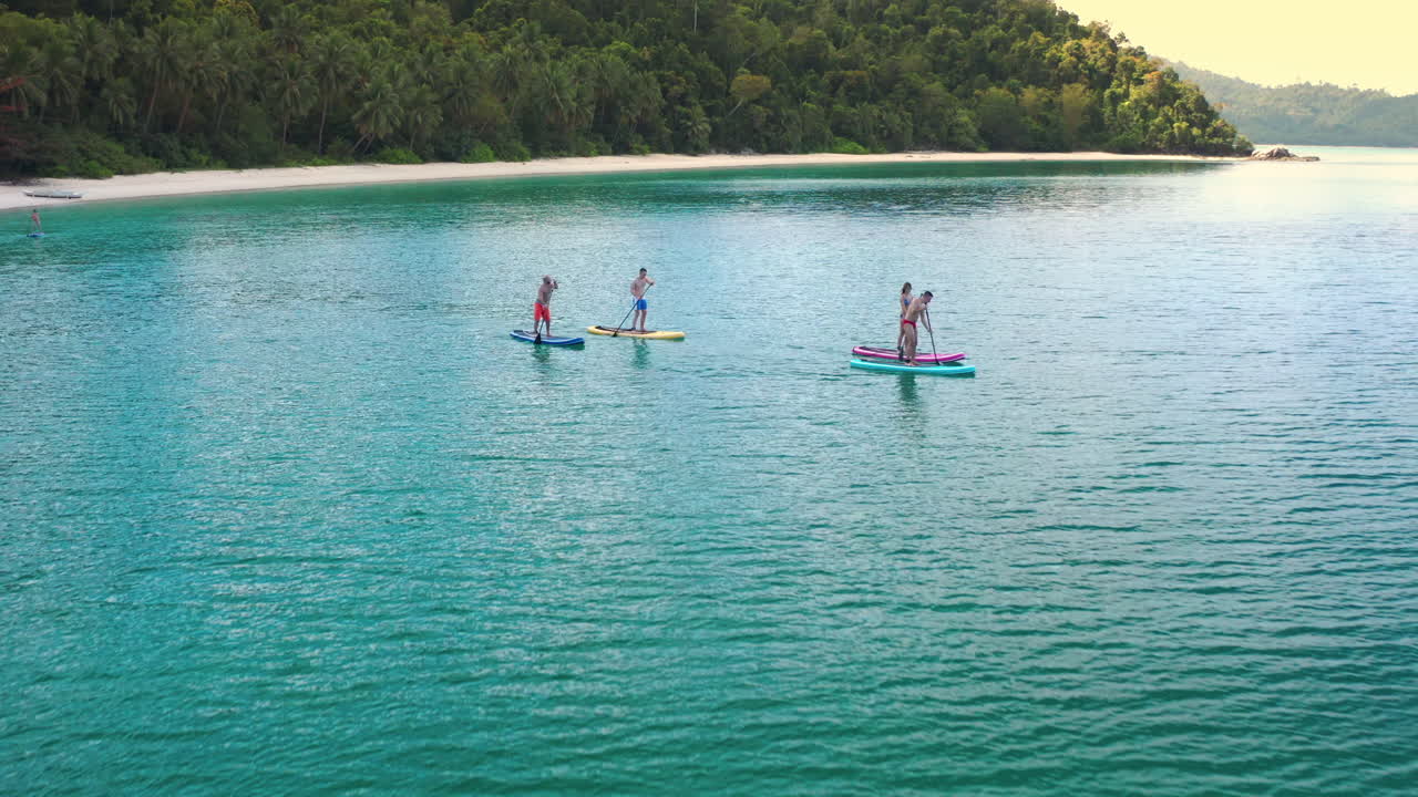 People Paddleboarding in Tropical Turquoise Waters