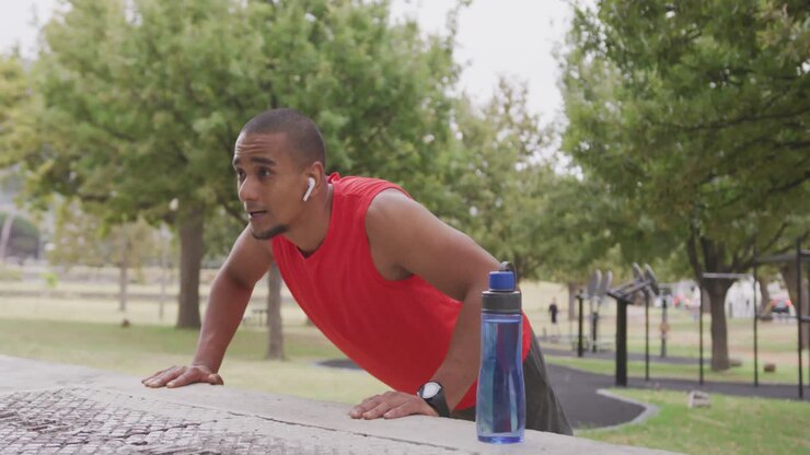 Side view man with prosthetic leg doing push ups