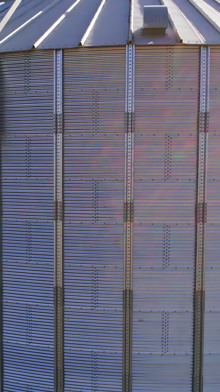 Granary grain elevators. Metal tanks for the storage crop. Large bins for farming. Vertical video