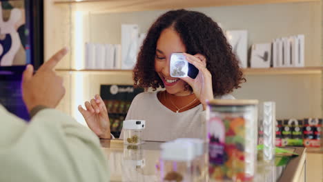 woman inspecting cannabis at a dispensary