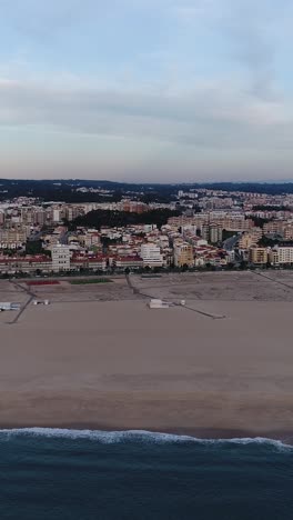 aerial view of a coastal city and sandy beach with waves