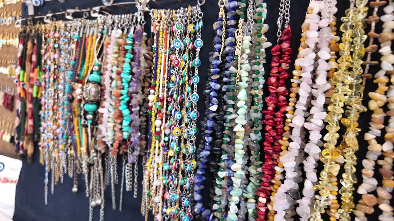 Colorful Necklaces and Bracelets Displayed at a Market