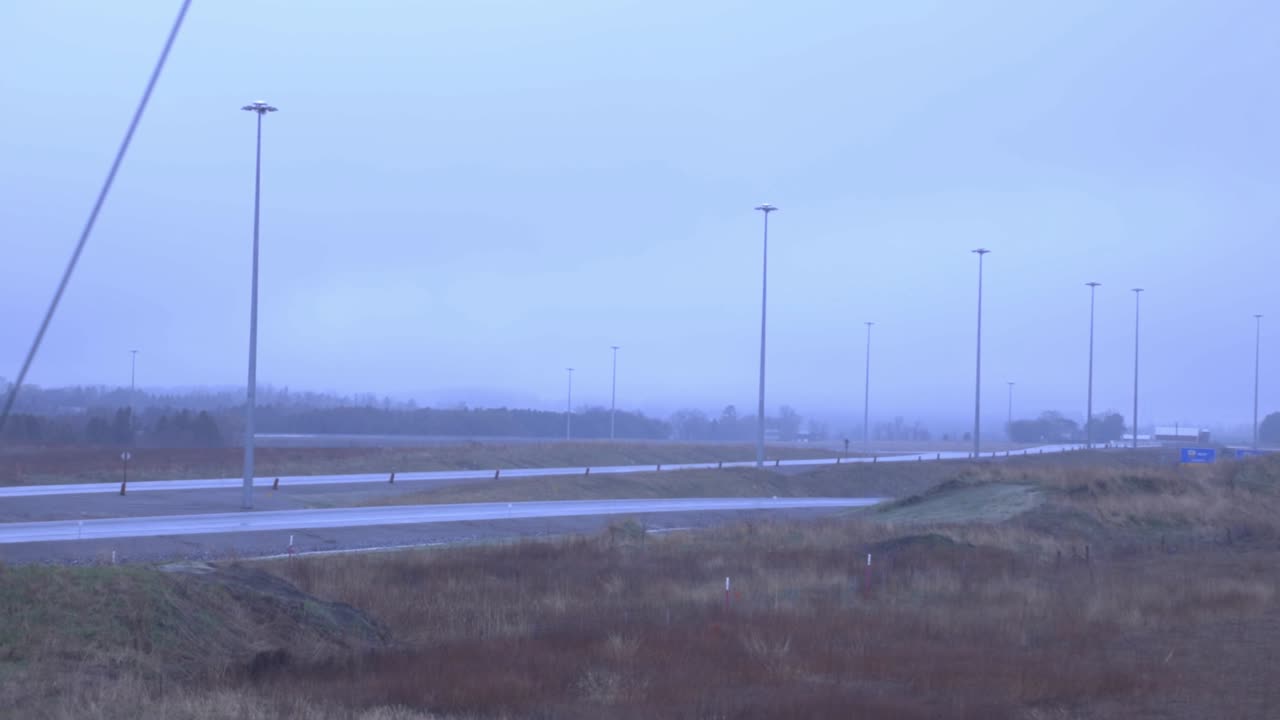 Two Separate Highway Road In The Countryside Under A Foggy Sky - Pan Wide Shot