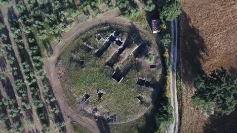 aerial drone ascending over poggio civitate etruscan ruins in murlo, tuscany