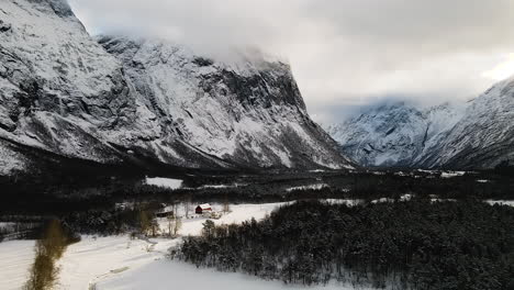 beautiful forest and mountain landscape in winter in norway - aerial shot