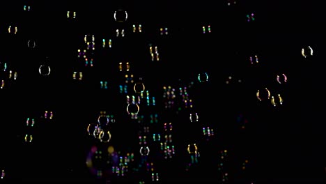 lot soap bubbles fly in the air black background lot of bright colorful soap bubbles do not fly very fast in the air black background