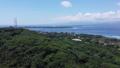 aerial view of tropical island coastline with village and ocean