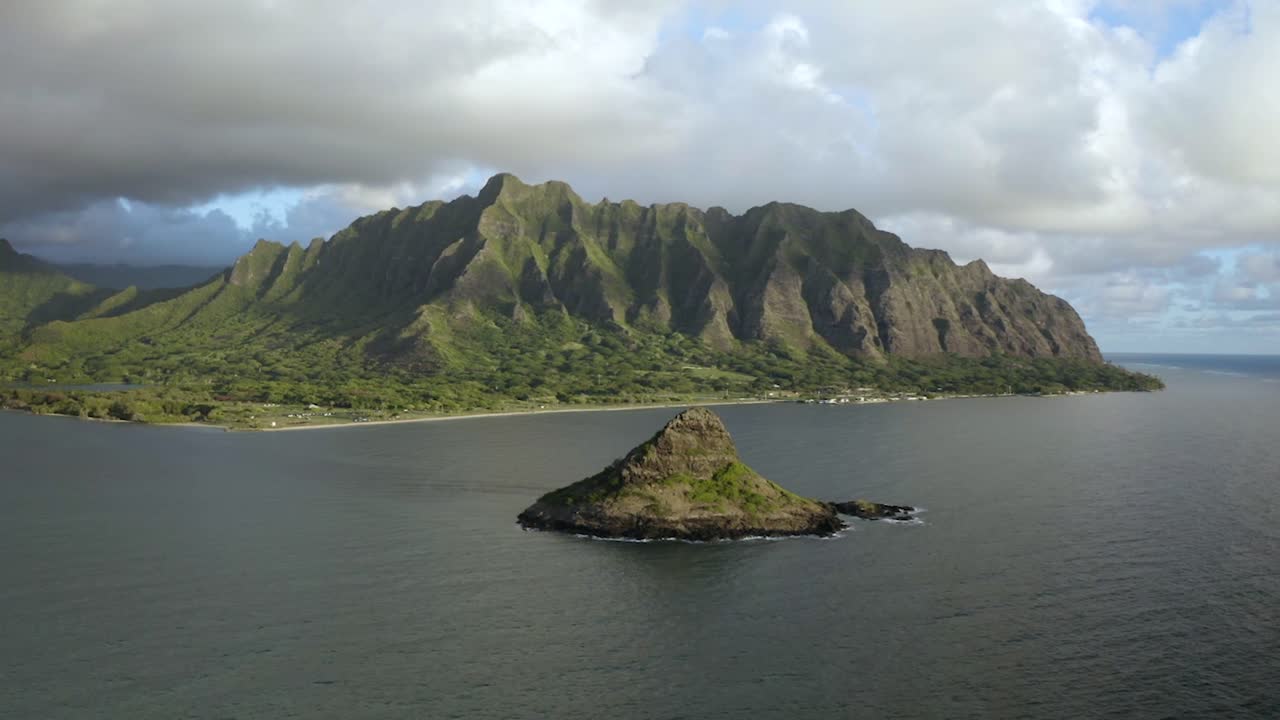 Full aerial view of Chinaman's Hat with the Kualoa Ranch mountains in the background