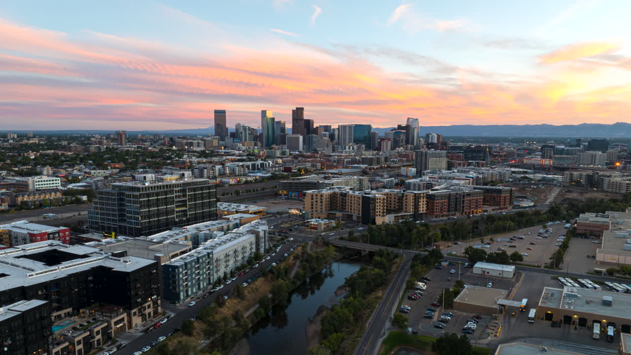 Sunset drone hyperlapse over River North Art District toward Denver city skyline