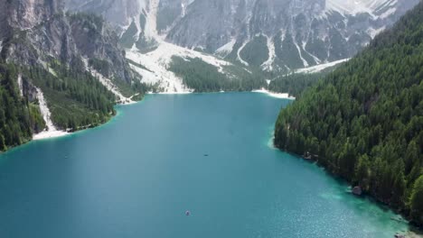 tilt-up from tranquil waters to majestic dolomite peaks at lake braies, italy