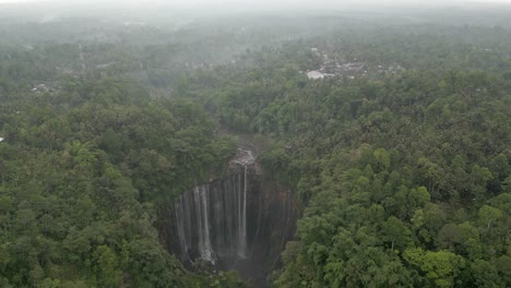 aerial view of misty jungle waterfall, tumpak sewu in java indonesia