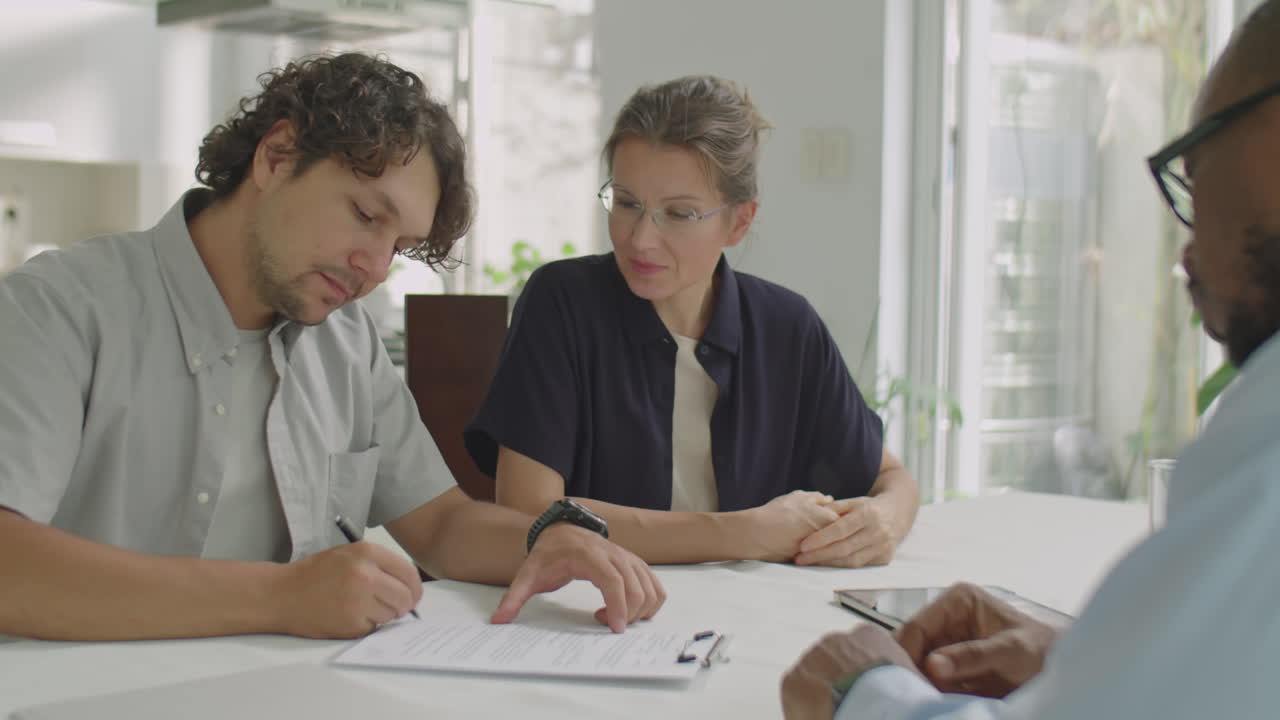Family Couple and Sales Representative Making Deal in Office