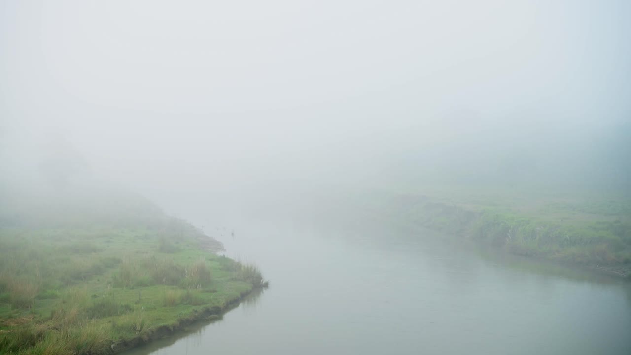 Misty Blue River Scenery Background, Thick Mist and Fog on a Foggy Morning in Chitwan National Park in Nepal in a Beautiful Minimal Minimalist Landscape Background with Copy Space