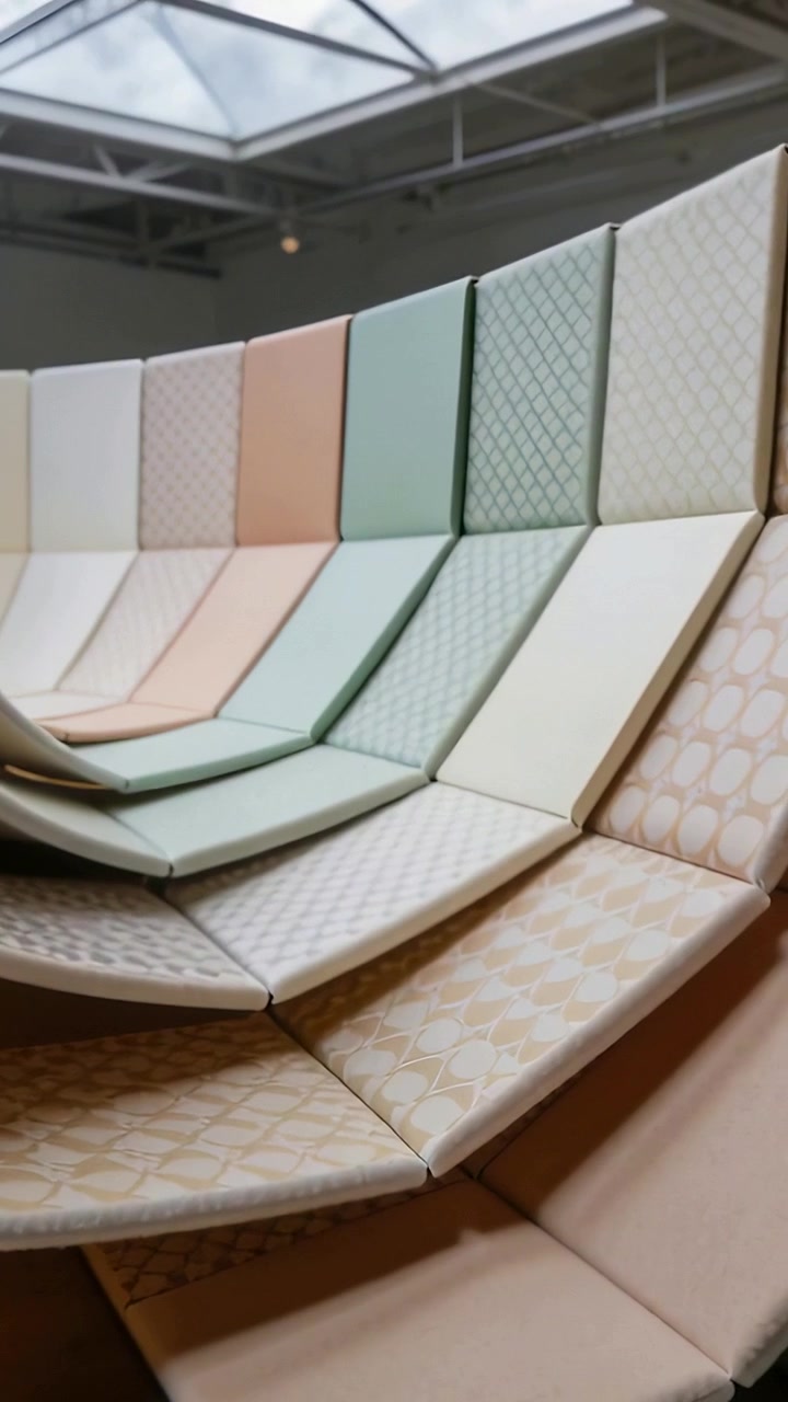 Vertical video: Panning camera revealing tiered seating in gallery, pastel cushions and skylight