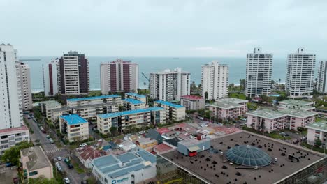 Bird's-eye-dolly-in-view-of-buildings-overlooking-the-sea-in-ViÃ±a-del-Mar,-Chile