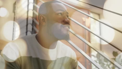 smiling man indoors with bokeh light animation in background