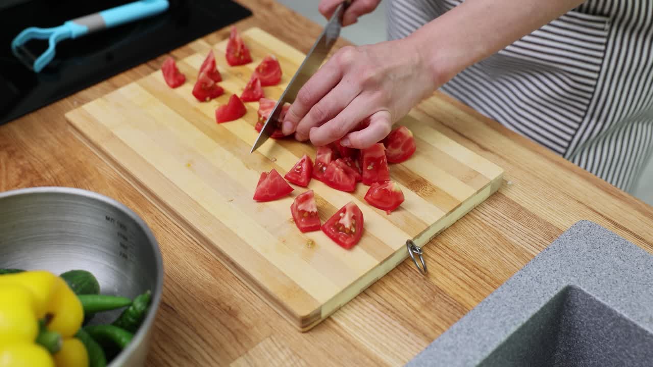 Chopping tomatoes on a cutting board