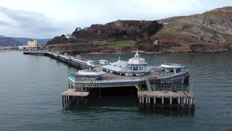 elegant stretching victorian welsh llandudno pier aerial rising pull back view on quiet morning