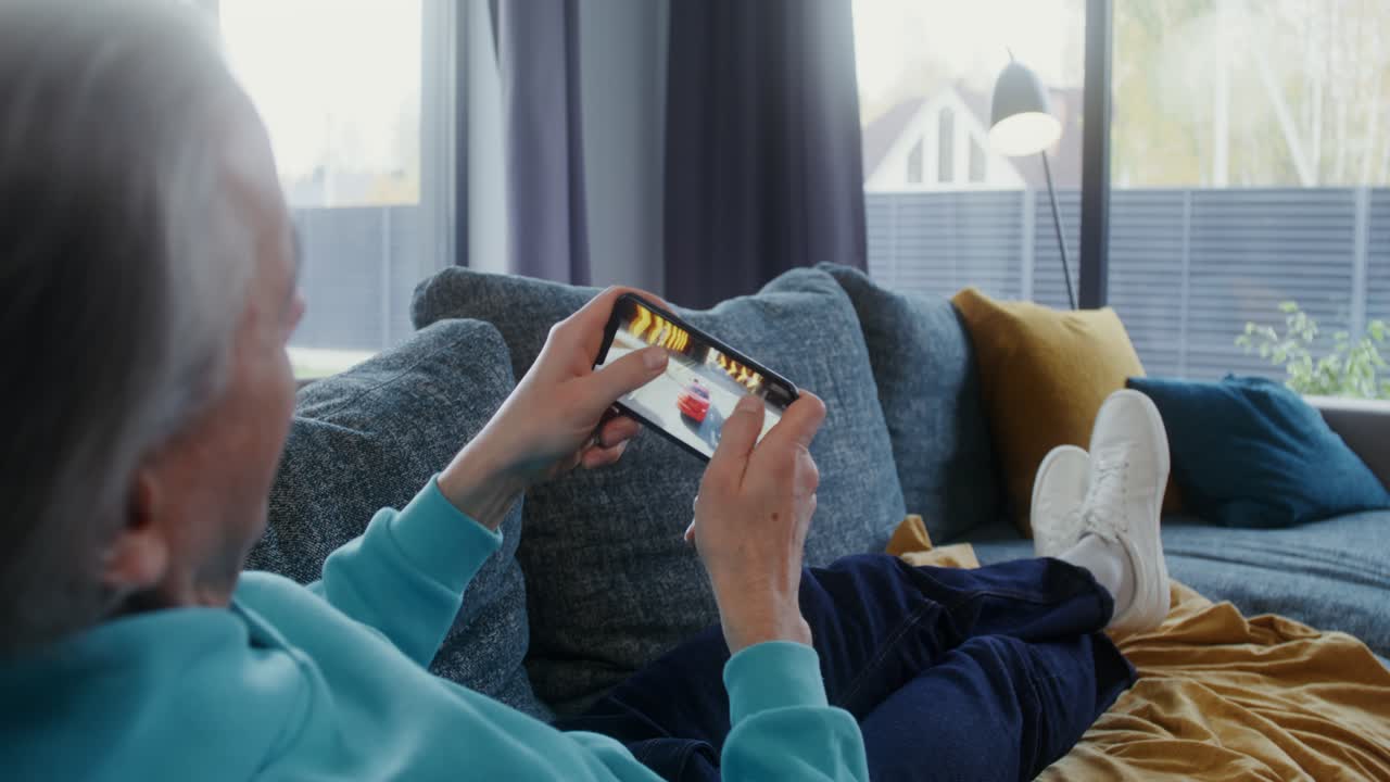 Man playing mobile game on smartphone