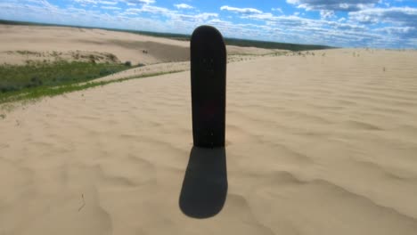 skateboard deck standing in the sand in the sand dunes on a sunny day near alberta canada