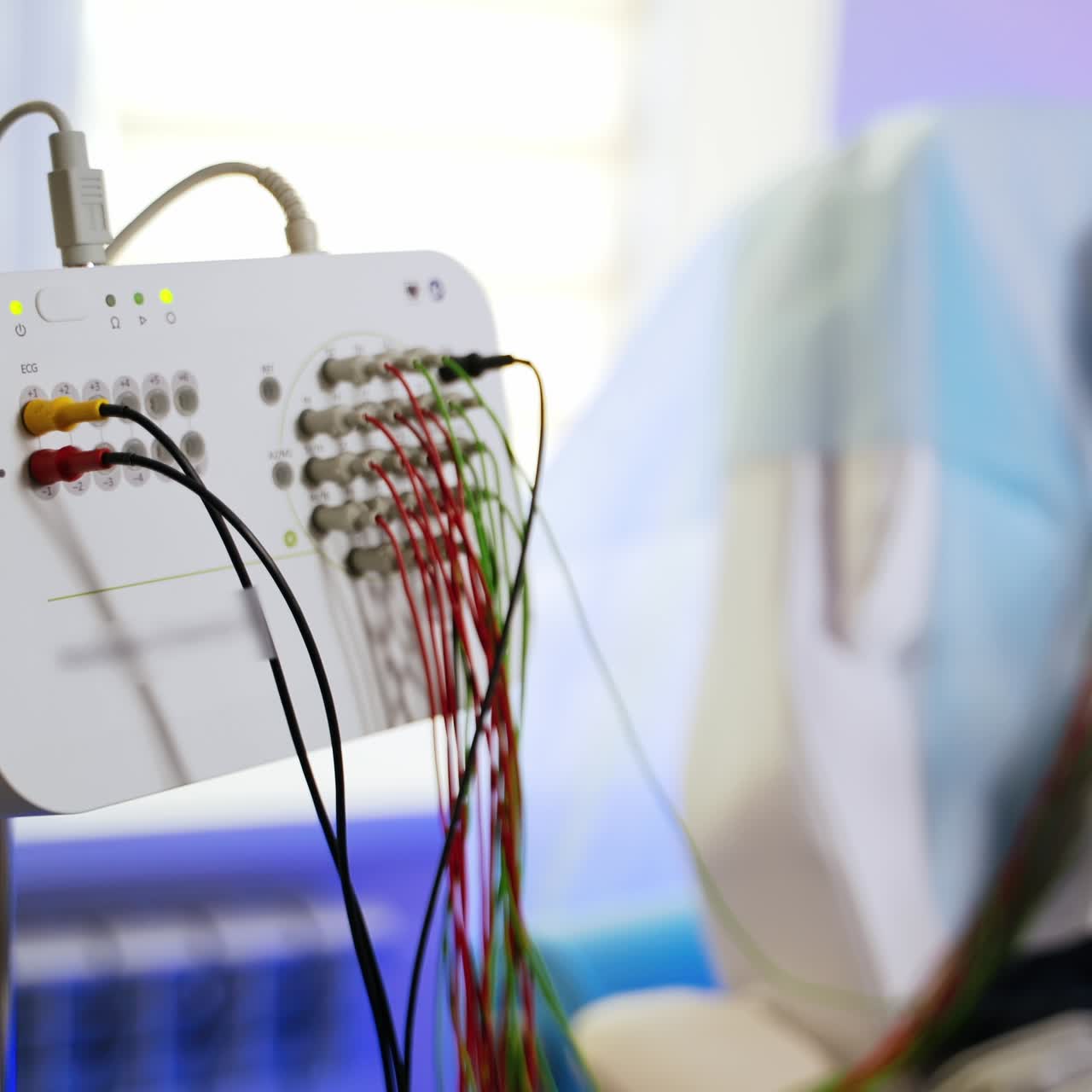 Modern advanced equipment for electroencephalographic examination. Teenage boy undergoing EEG testing at backdrop in blur