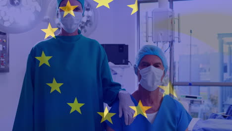 animation of flag of european union over caucasian female and male surgeons in face mask