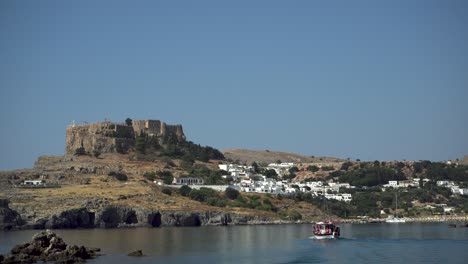 acropolis of lindos with lovely white old town houses close to mediterranean sea