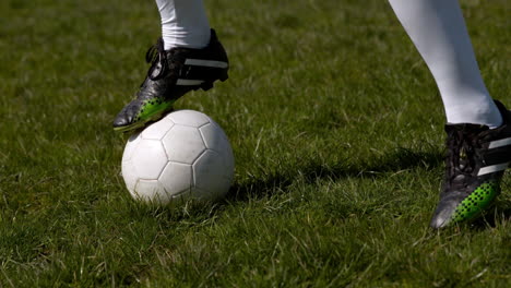 football player controlling the ball on grass