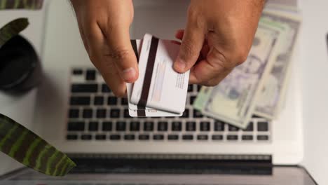 close-up of hispanic male hands holding multiple credit cards